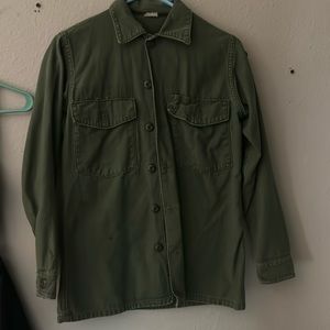 Army green jacket with red patch on the side